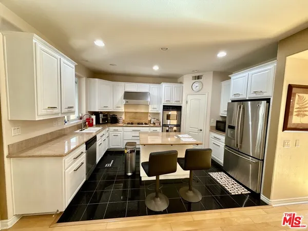 a kitchen with refrigerator and cabinets