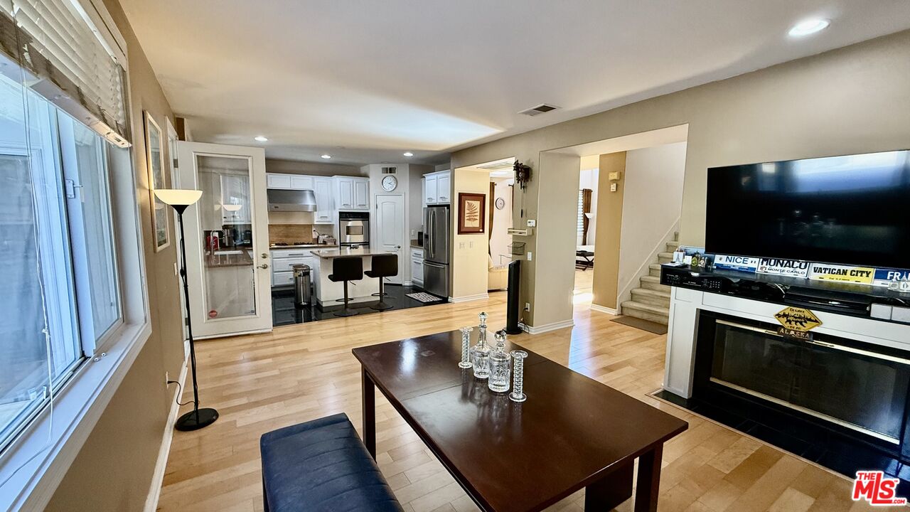 2078 Nohl Ranch Road Orange, CA 92867 - Photo 8 of 13 a living room with stainless steel appliances furniture a flat screen tv and kitchen view