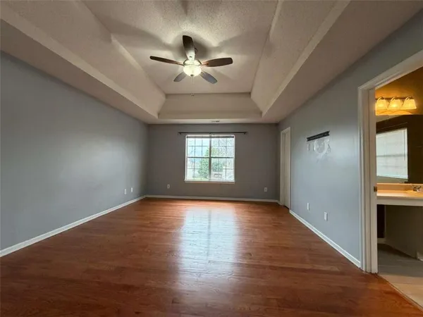 a bathroom with a granite countertop sink a toilet and a mirror