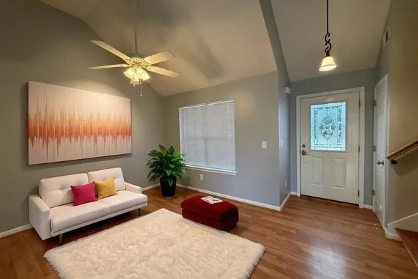 a view of a room with wooden floor