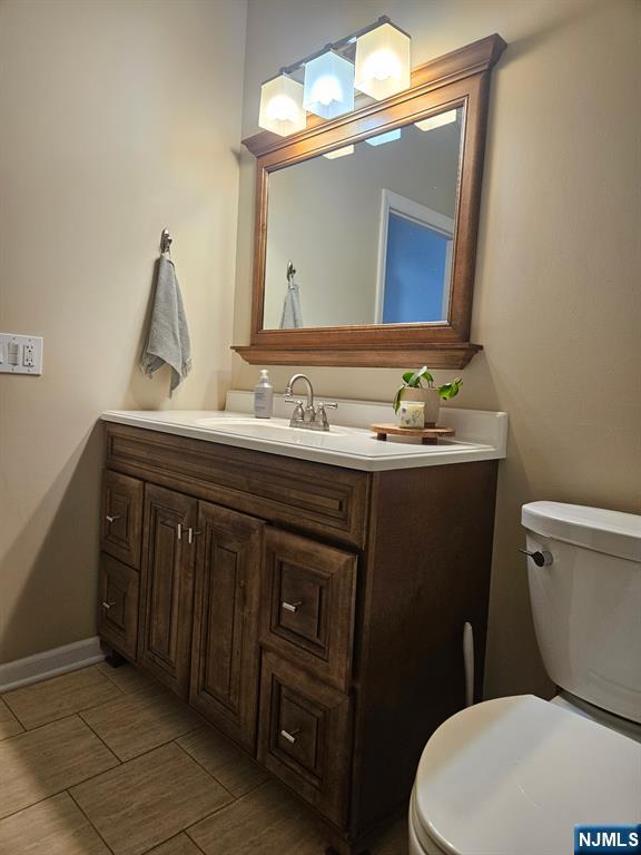 15 William Street, Unit 2 Rochelle Park, NJ 07662 - Photo 8 of 12 a bathroom with a toilet sink and mirror