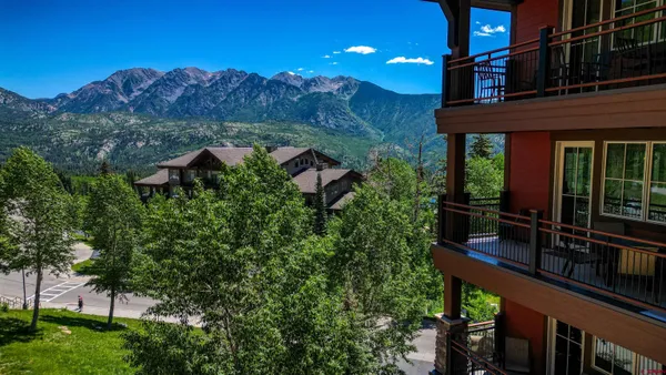 a kitchen with stainless steel appliances granite countertop a refrigerator sink and stove