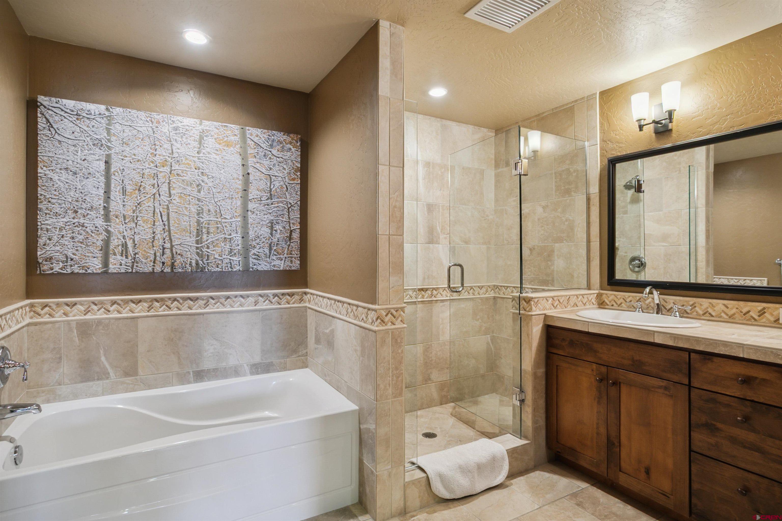 24 Sheol Street, Unit R302 Durango, CO 81301 - Photo 17 of 45 a bathroom with a bathtub shower sink mirror and toilet