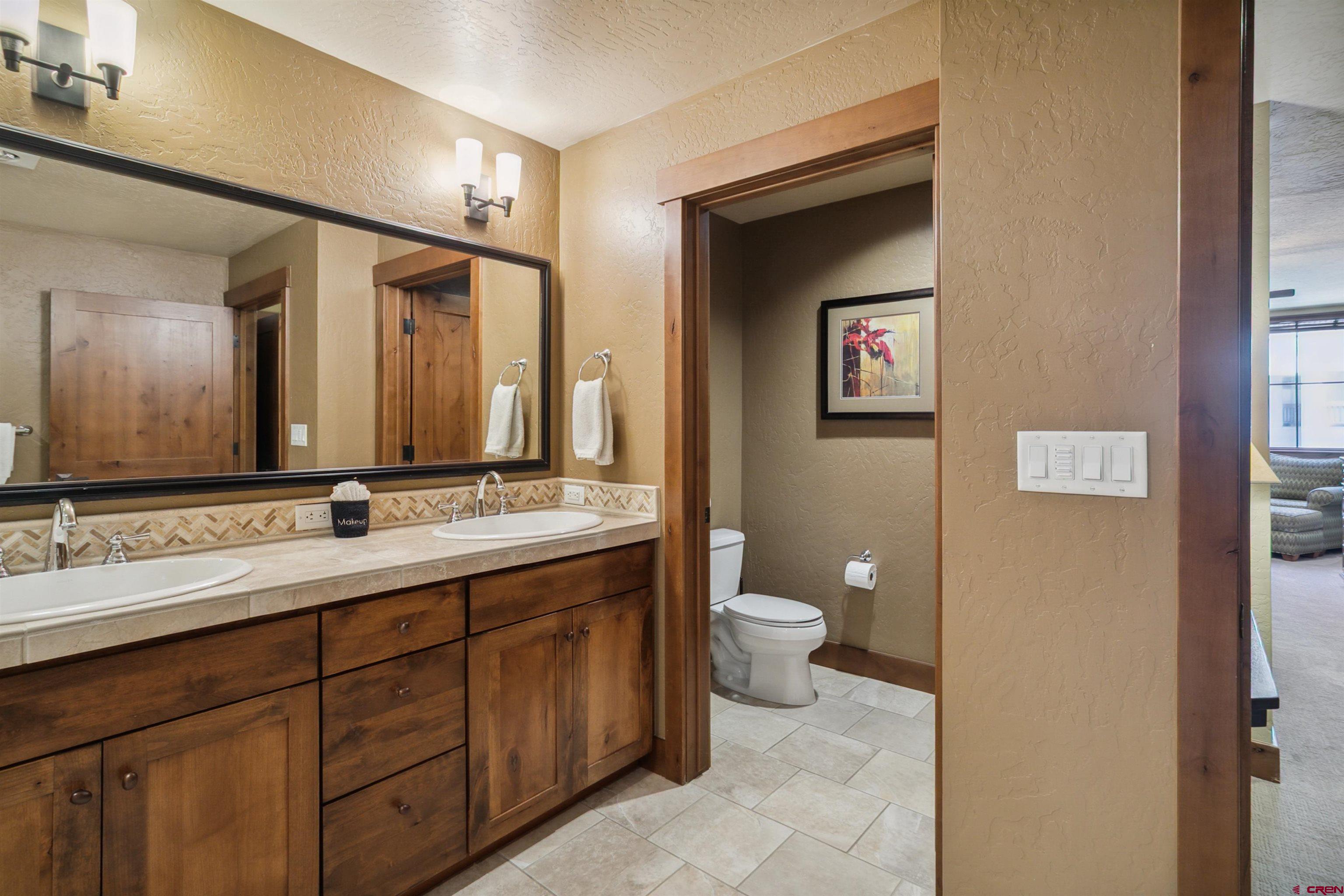 24 Sheol Street, Unit R302 Durango, CO 81301 - Photo 18 of 45 a bathroom with a toilet sink double vanity and mirror