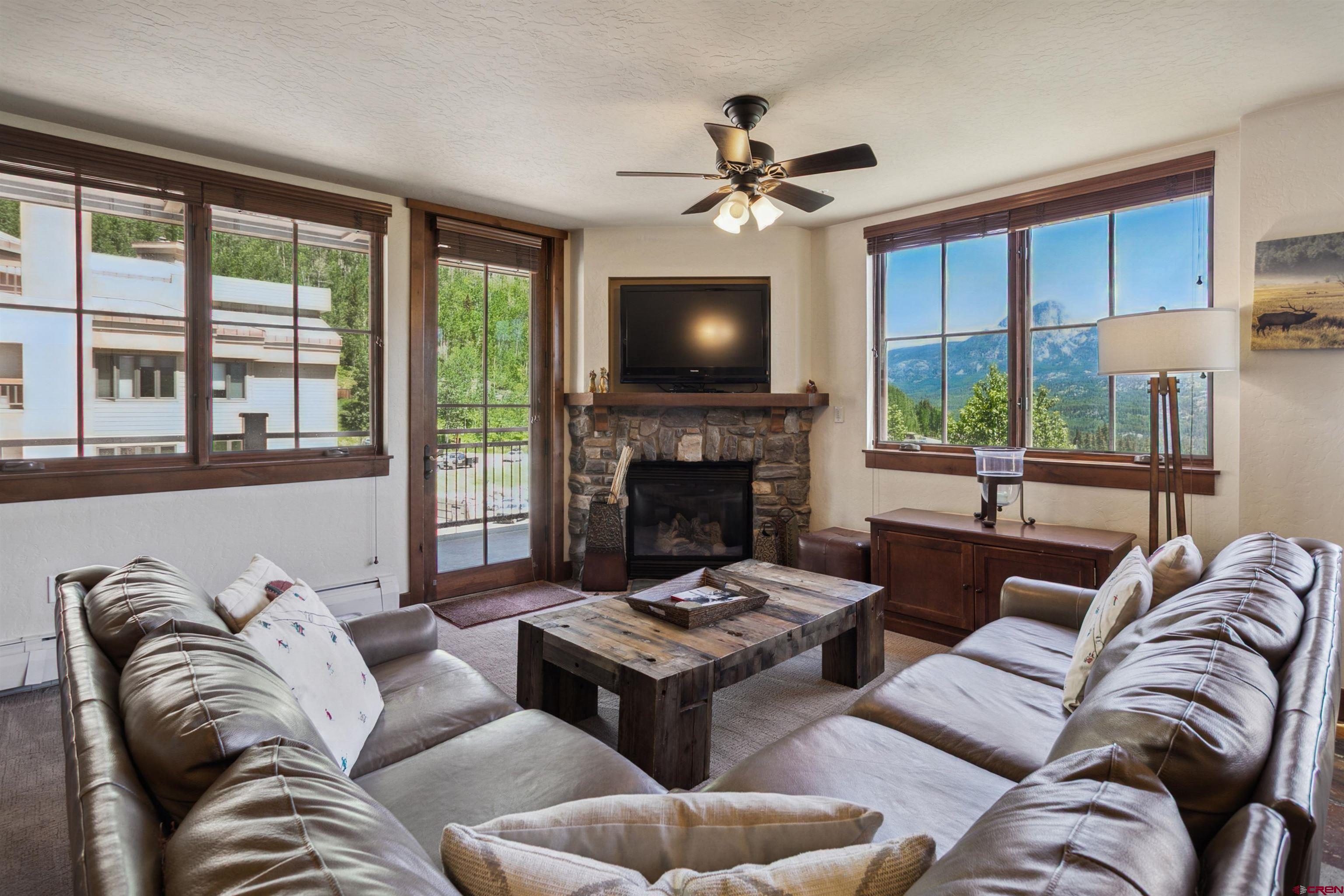 24 Sheol Street, Unit R302 Durango, CO 81301 - Photo 20 of 45 a living room with furniture a flat screen tv and a fireplace