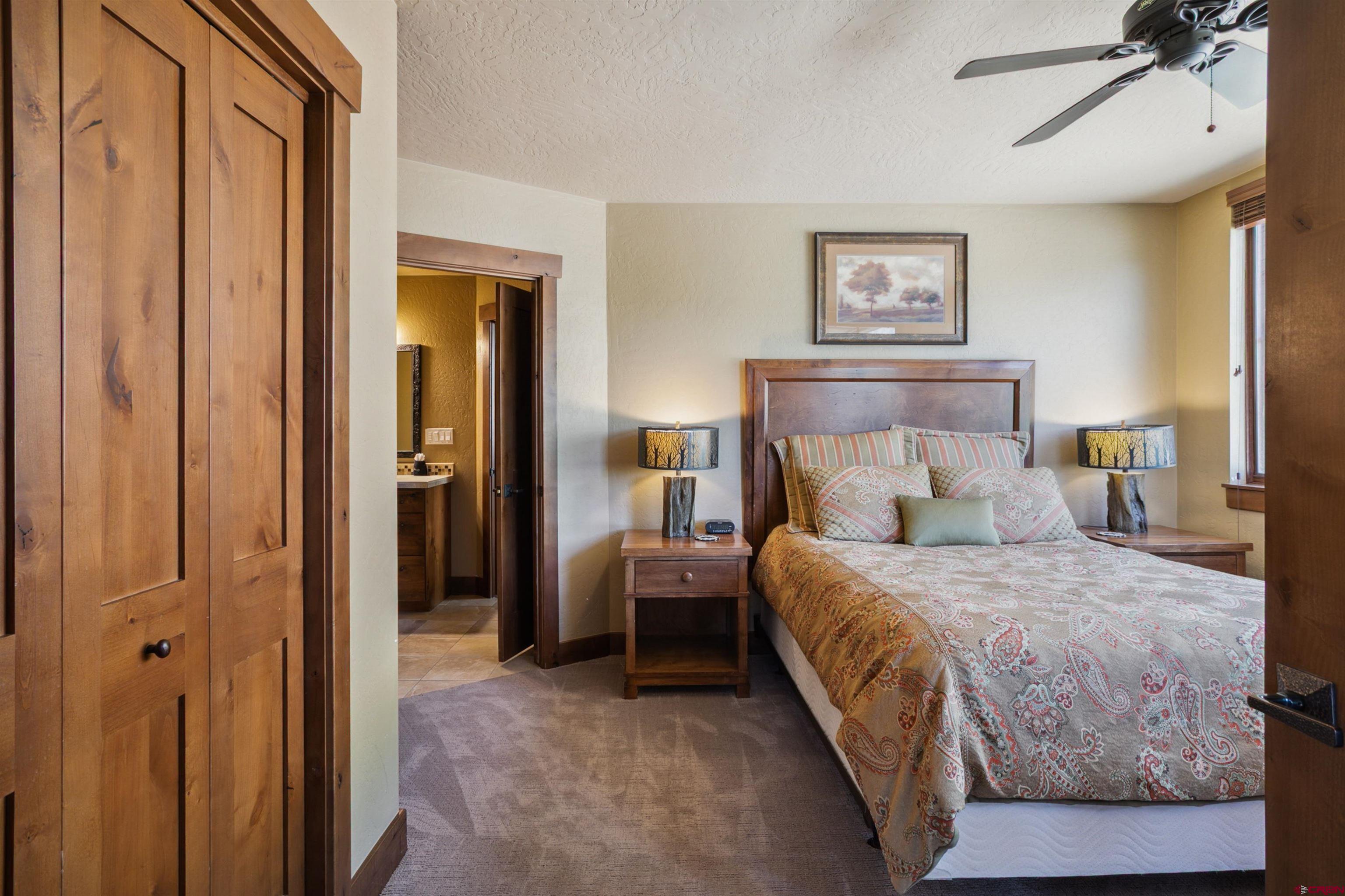 24 Sheol Street, Unit R302 Durango, CO 81301 - Photo 23 of 45 a bedroom with a bed and a mirror