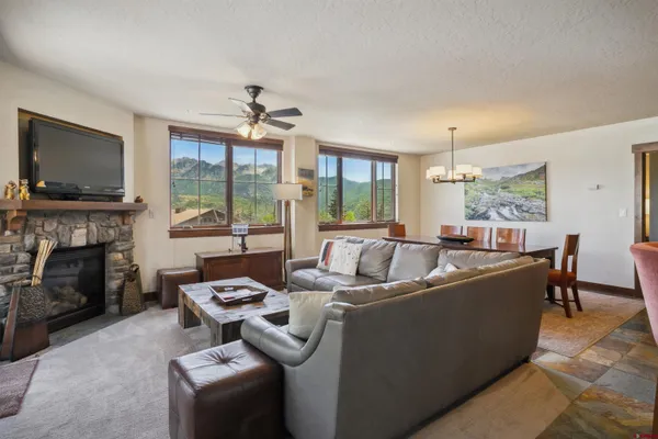a bedroom with a large bed and a chandelier fan
