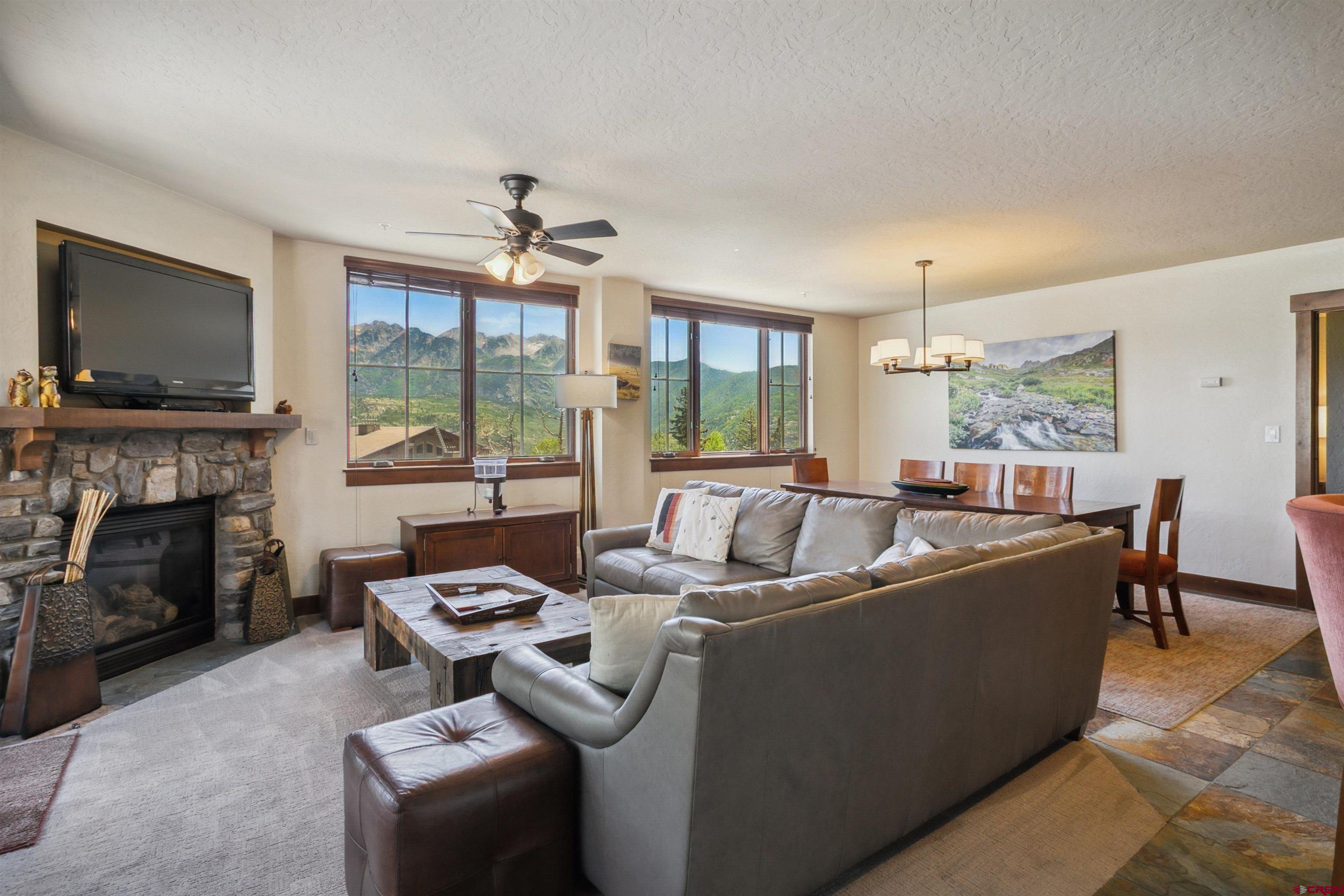 24 Sheol Street, Unit R302 Durango, CO 81301 - Photo 23 of 45 a living room with furniture a fireplace and a flat screen tv