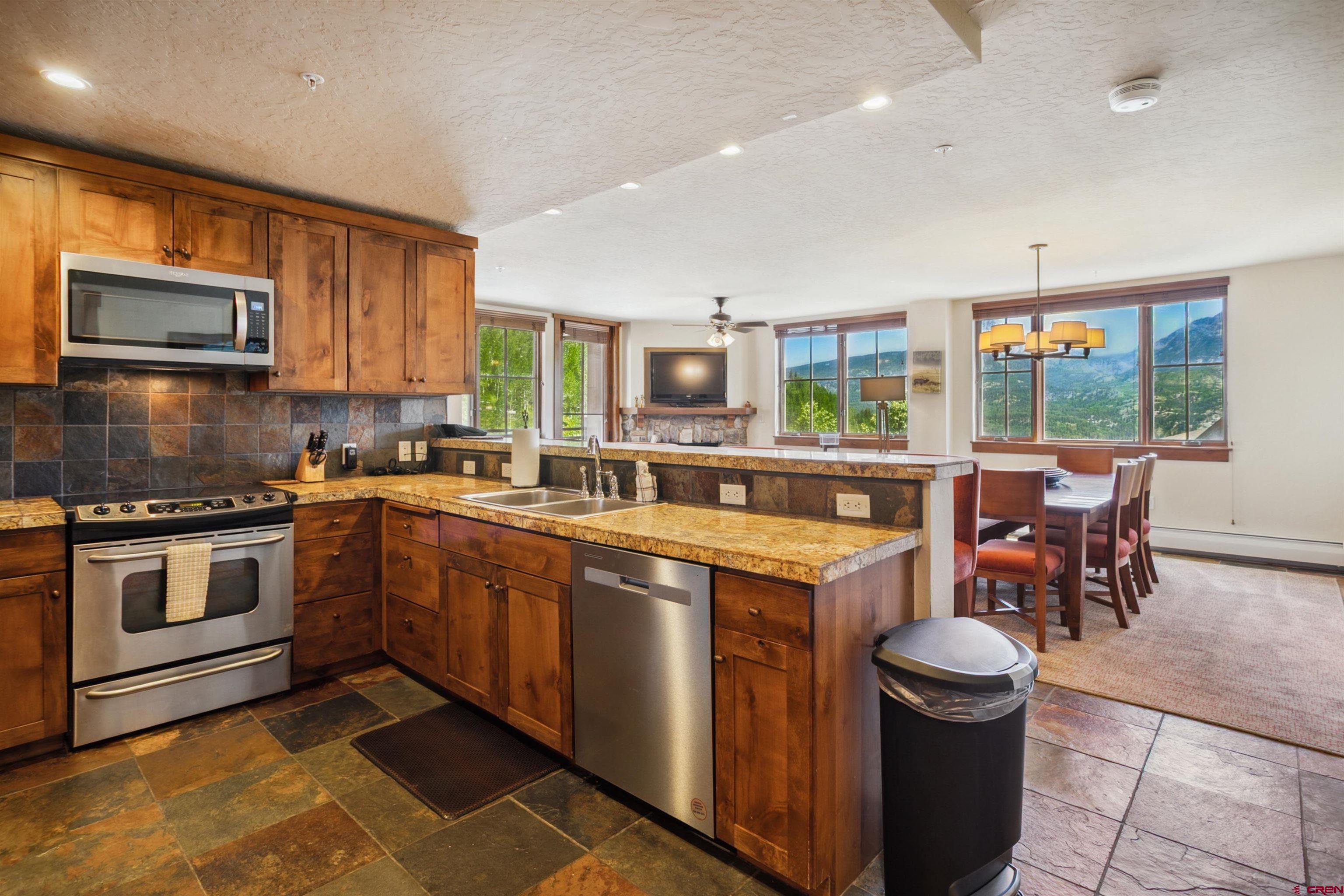 24 Sheol Street, Unit R302 Durango, CO 81301 - Photo 25 of 45 a kitchen with a sink stove and microwave