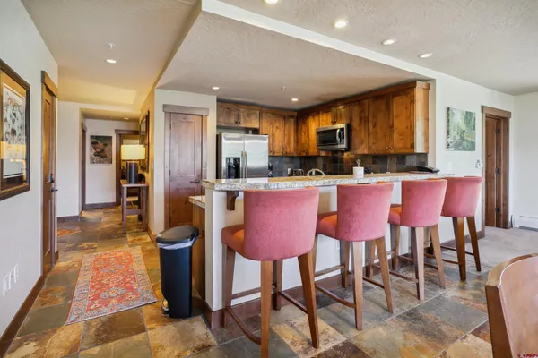 a view of a park with large trees and a barn in it