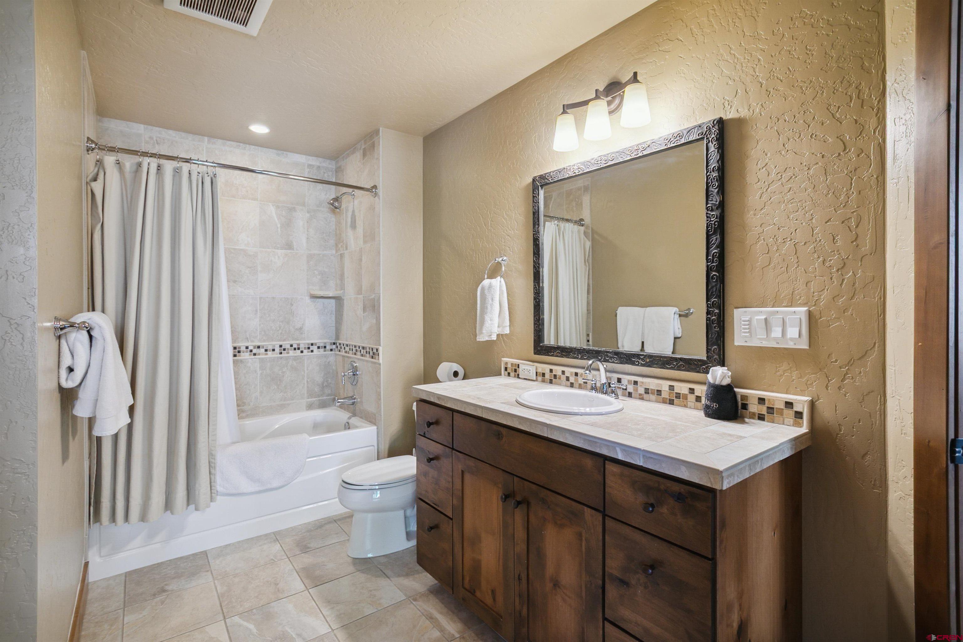 24 Sheol Street, Unit R302 Durango, CO 81301 - Photo 38 of 45 a bathroom with a sink double vanity mirror and a toilet