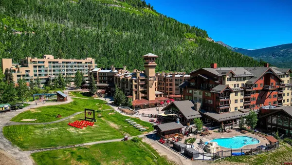 a view of a chair and fire pit in the middle of the forest