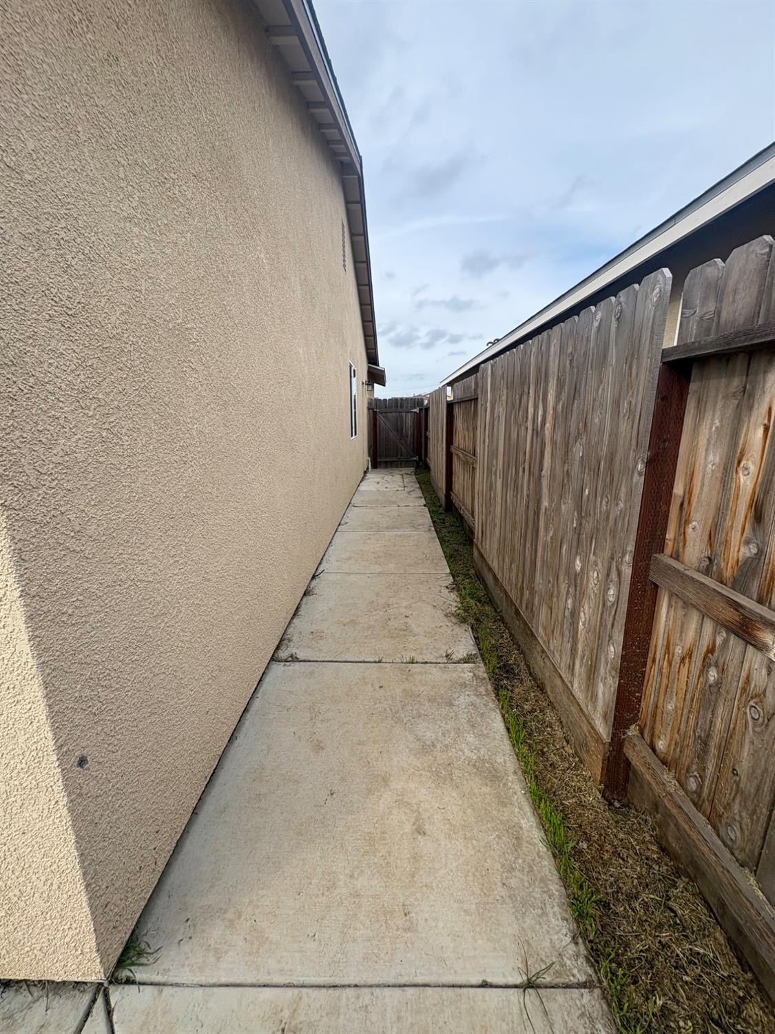 628 Marcus Street Merced, CA 95341 - Photo 4 of 21 Sidewalks both sides of the home.