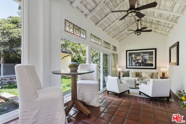 a living room with furniture a window and a table