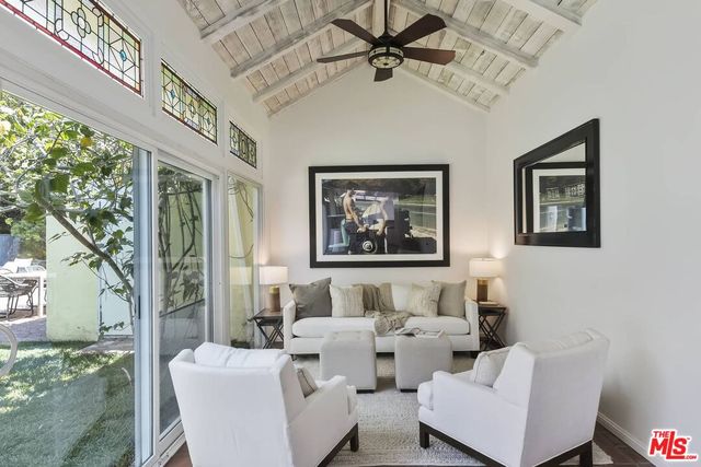 a living room with furniture ceiling fan and a rug