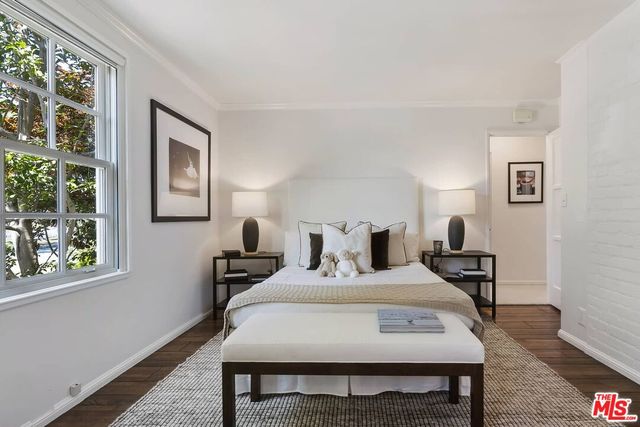 a view of a workspace with furniture and window