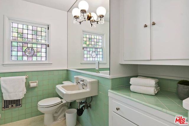 a bathroom with a sink toilet and a window