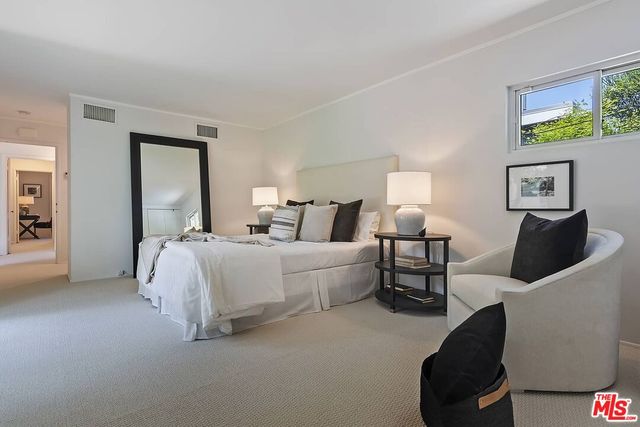 a bedroom with bed and a couch