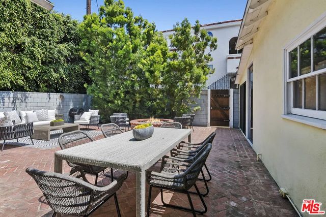 a view of a patio with table and chairs and potted plants