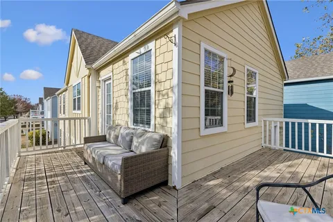 a balcony with couch and a window
