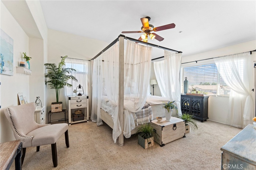 5922 Abernathy Drive Riverside, CA 92507 - Photo 14 of 29 a bedroom with furniture and a chandelier