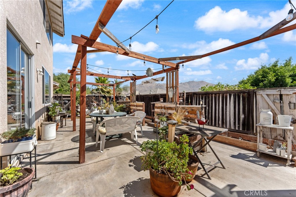 5922 Abernathy Drive Riverside, CA 92507 - Photo 22 of 29 a view of a patio with table and chairs potted plants