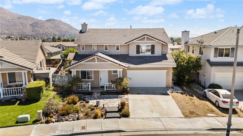5922 Abernathy Drive Riverside, CA 92507 - Photo 4 of 29 a view of a white house with a yard and potted plants