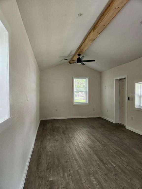212 Broad Street, Unit 10 Masaryktown, FL 34604 - Photo 3 of 4 an empty room with wooden floor cabinet and windows