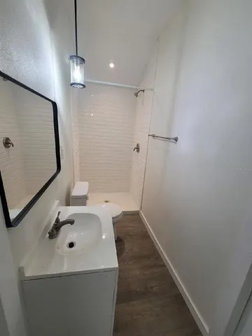 a bathroom with a sink a toilet and vanity