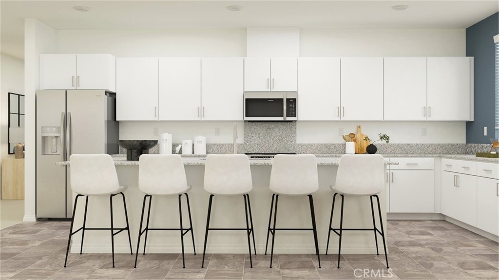 369 Deer Lane Way Perris, CA 92570 - Photo 1 of 15 a kitchen with stainless steel appliances granite countertop a table chairs microwave and sink