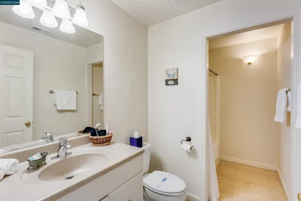a en suite bathroom with a sink double vanity and a mirror