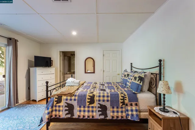 a bed room with a bed and a tv