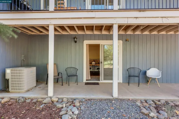 a kitchen with granite countertop a sink a window and cabinets
