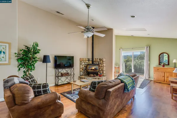 a kitchen with a table chairs microwave and cabinets