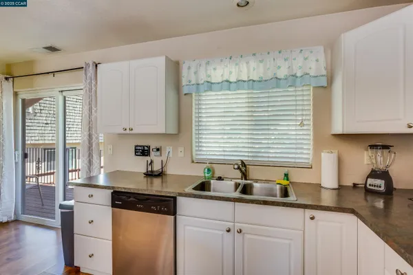 a kitchen with stainless steel appliances granite countertop white cabinets sink and stove