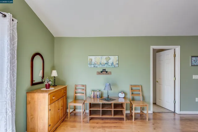 a bedroom with two beds and a potted plant