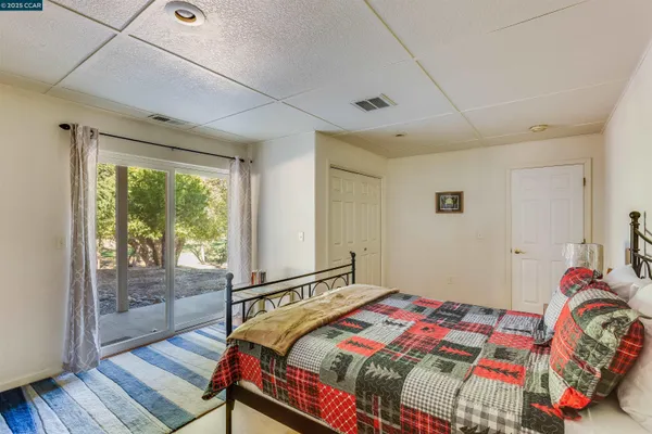 a living room with furniture a dining table and a flat screen tv
