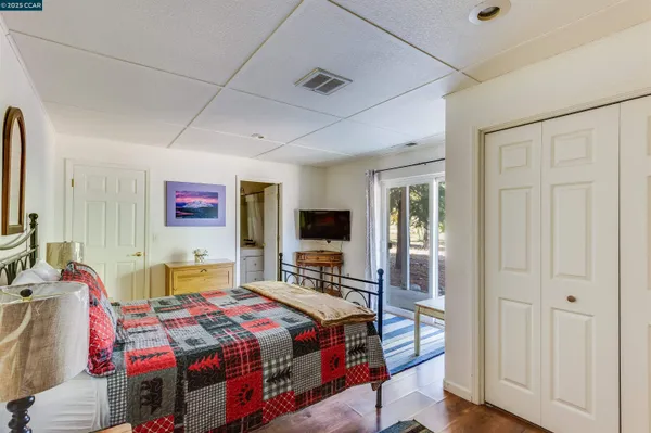 a living room with furniture a ceiling fan and a flat screen tv