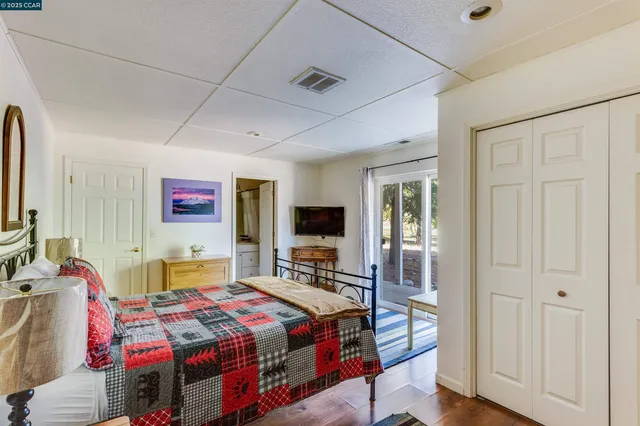 a living room with furniture a ceiling fan and a flat screen tv