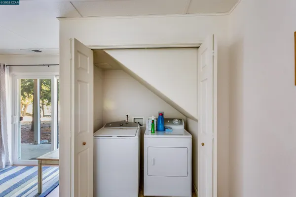 a living room with furniture a ceiling fan and a flat screen tv
