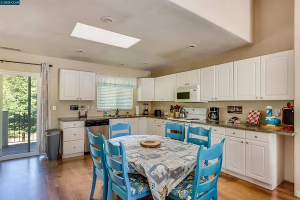 a kitchen with stainless steel appliances white cabinets and sink