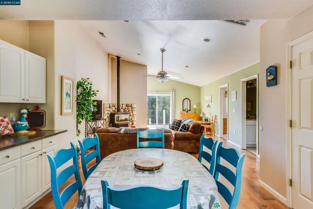 a kitchen with stainless steel appliances granite countertop white cabinets sink and a granite counter top
