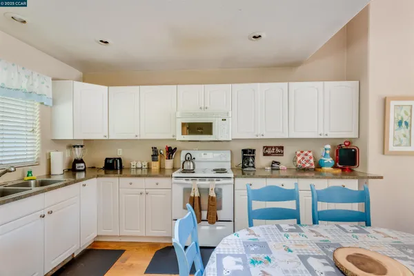 a living room with furniture a chandelier and a flat screen tv