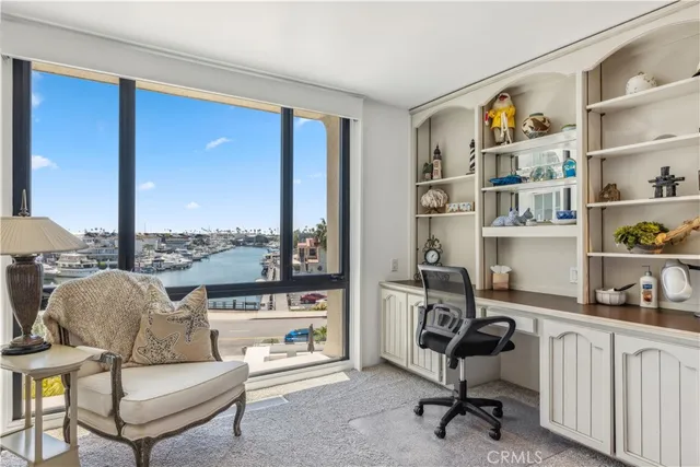 a view of a livingroom with workspace and a couch