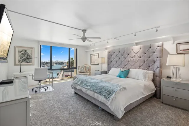 a spacious bedroom with a bed a couch and dresser