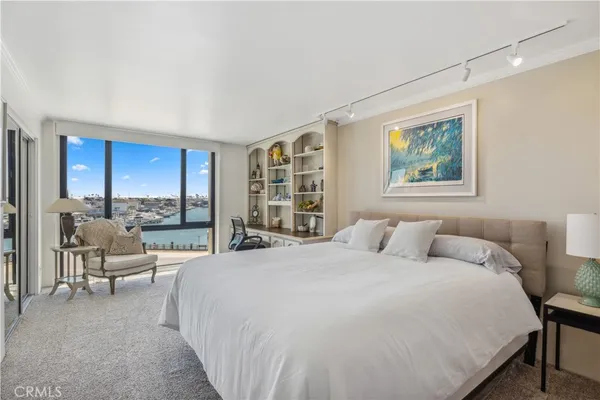 a bedroom with a large bed couch and a window