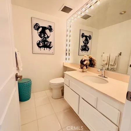 a bathroom with a sink mirror and toilet
