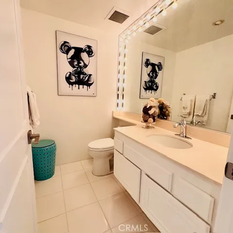 a bathroom with a sink mirror and toilet