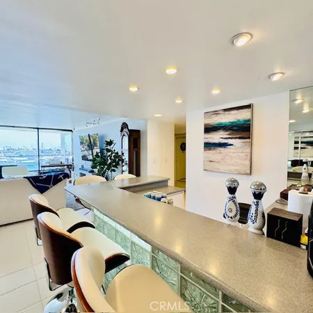 a room with furniture a large window and wooden floor