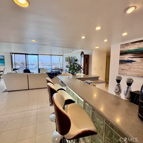 a large kitchen with stainless steel appliances a large counter top a stove and a sink